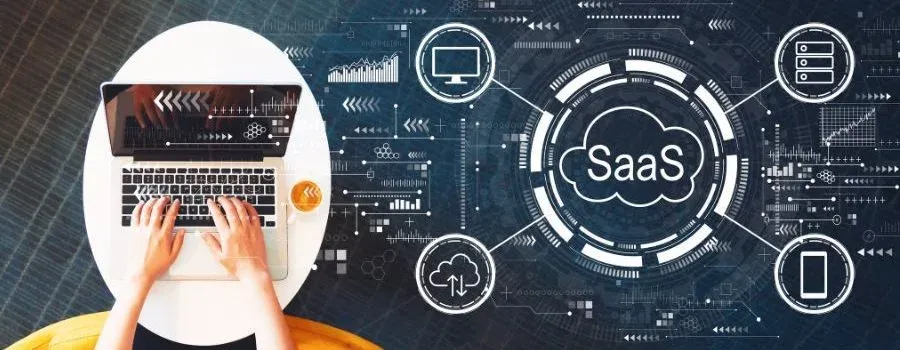 Hands typing on a laptop next to SaaS and cloud icons